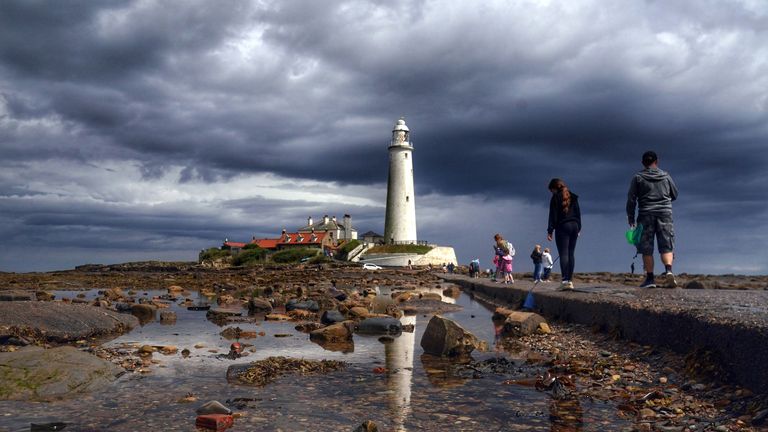 Storm clouds gather over St Mary&#39;s Lighthouse in Whitley Bay on the north east coast of England
