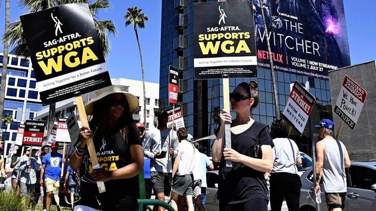 Actors and writers walk the picket line in front of Netflix&#39;s headquarters building in Hollywood, Los Angeles on July 13, 2023. SAG-AFTRA announced to start striking on wage and use of AI on July 14th. ( The Yomiuri Shimbun via AP Images )