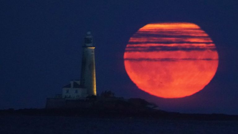 The Full Buck supermoon rises over St Mary&#39;s Lighthouse in Whitley Bay on the North East coast of England. The July supermoon is arriving to its closest point to Earth at 224,895 miles (361,934km) - around 13,959 miles (22,466km) closer than usual. It appears 5.8 per cent bigger and 12.8 per cent brighter than an ordinary full moon. Picture date: Monday July 3, 2023.