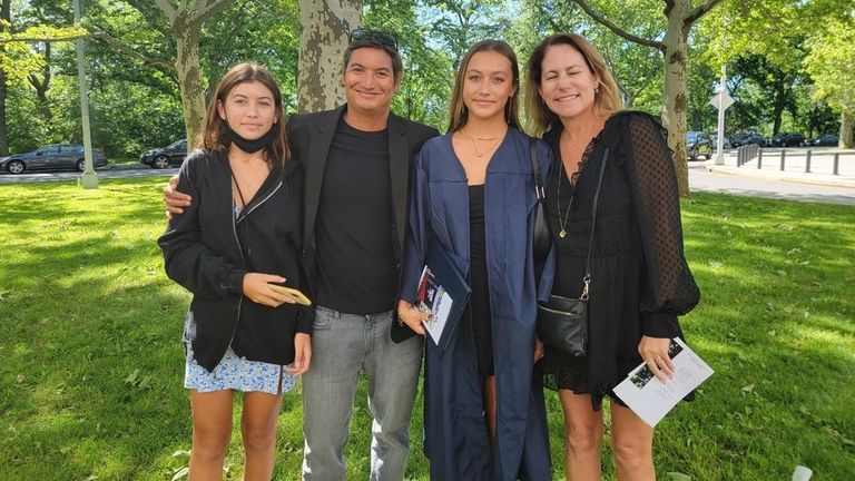 Mikala Jones in New York with his daughter Violet, left, and on the right, daughter Bella and wife Emma Brereton.