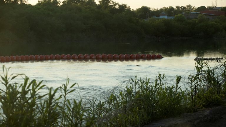 An unfinished strand of orange buoys in the Rio Grande River