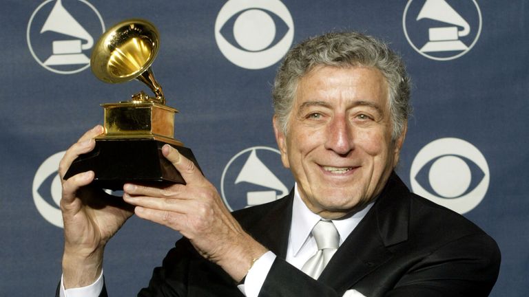 Singer Tony Bennett poses for photographers with his Grammy Award for Best Traditional Pop Vocal Album for "Playin&#39; With My Friends: Bennett Sings The Blues," at the 45th annual Grammy Awards at New York&#39;s Madison Square Garden, February 23, 2003. REUTERS/Peter Morgan MS/HB
