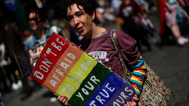 People carry banners during the Pride march in Liverpool, Britain, July 29, 2023. REUTERS/Phil Noble
