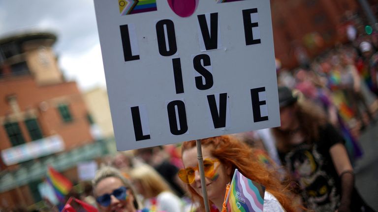 People carry banners during the Pride march in Liverpool, Britain, July 29, 2023. REUTERS/Phil Noble
