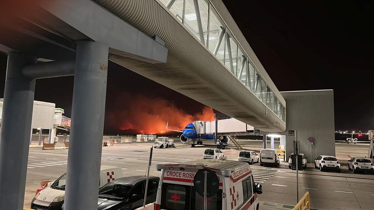 A wildfire burns near the Sicilian airport "Falcone-Borsellino" in Punta Raisi near Palermo, Italy
Pic:Ufficio Stampa Gesap/Reuters