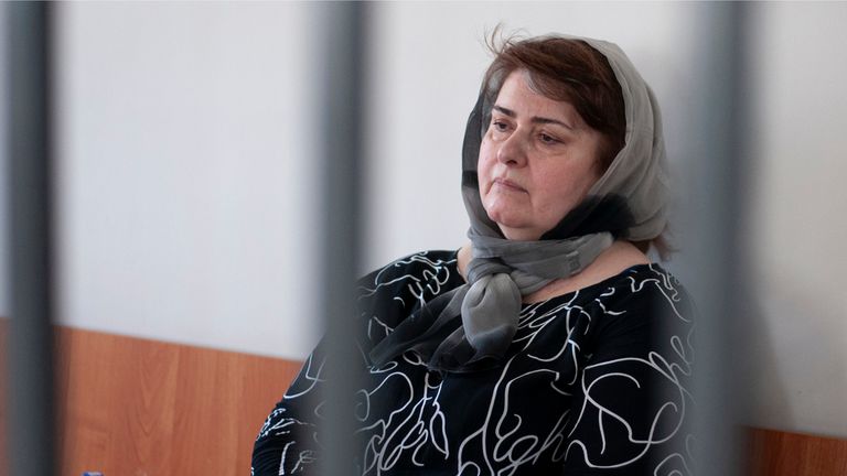 Zarema Musayev sits behind bars in a courtroom a in Grozny, Russia, Tuesday, July 4, 2023. Musayev is the mother of two local activists who have challenged Chechen authorities and has been in custody in Chechnya since her arrest in January 2022. Unidentified masked assailants in the Russian province of Chechnya attacked and beat Novaya Gazeta journalist Elena Milashina and lawyer Alexander Nemov on Tuesday, who had just arrived in Chechnya to attend the trial of Musayeva. (AP Photo)