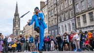 Street performer Malachi Frost entertains the crowds on Edinburgh&#39;s Royal Mile during the city&#39;s Festival Fringe