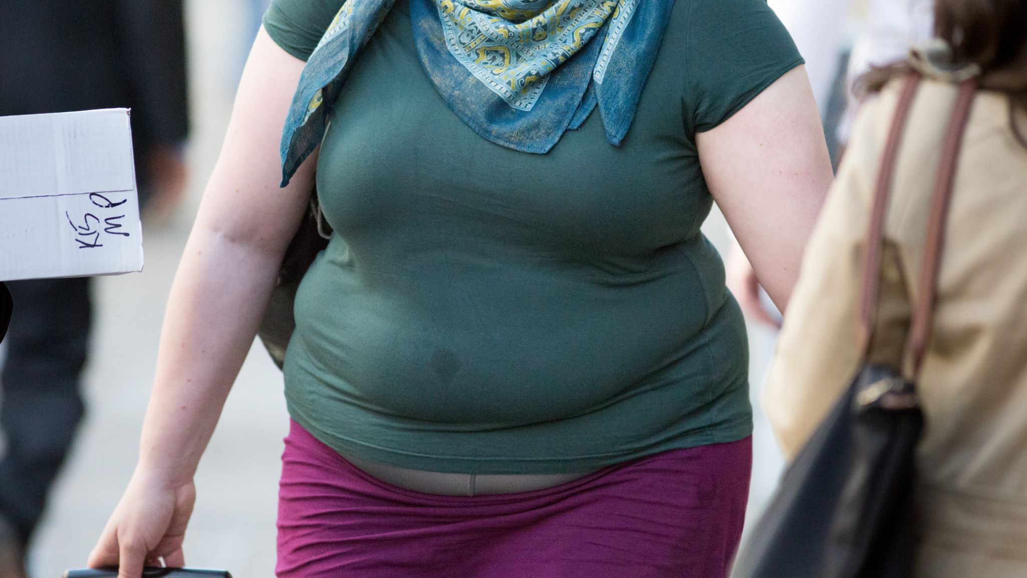 Cropped image of overweight fat woman back with obesity, excess