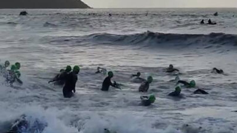 Two men died after getting into difficulty in the water at an Ironman event in southern Ireland