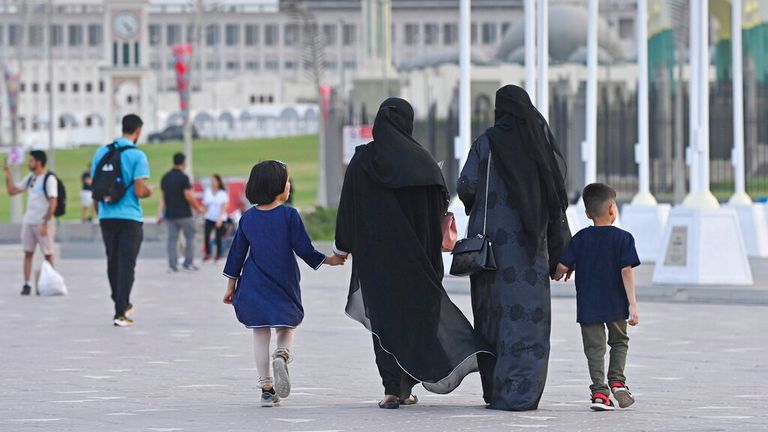 Arab women and children in traditional robes, dresses, black abaya, veils, veiled, Soccer World Cup 2022 in Qatar. Pic: AP