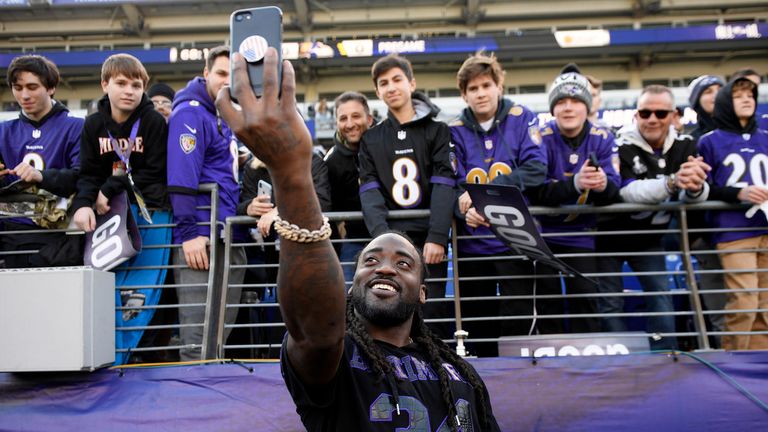 Baltimore Ravens running back Alex Collins (34) takes a photo with fans. Pic: AP