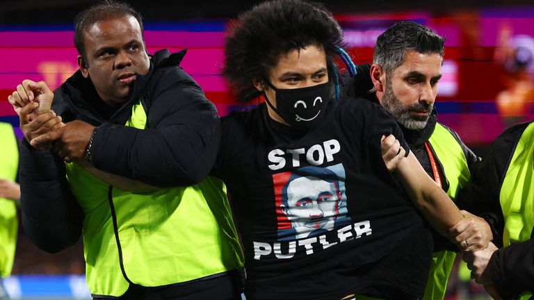 Soccer Football - FIFA Women&#39;s World Cup Australia and New Zealand 2023 - Final - Spain v England - Stadium Australia, Sydney, Australia - August 20, 2023 A pitch invader wearing a shirt in protest against Russia&#39;s president Vladimir Putin is detained by stewards REUTERS/Hannah Mckay