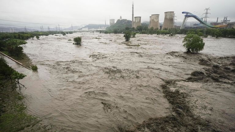 A swollen river in Beijing. Pic: Kyodo via AP
