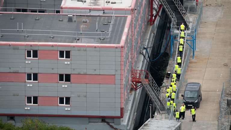 Workers return to the Bibby Stockholm accommodation barge at Portland Port in Dorset after what is believed to be a fire drill. The Home Office have said around 50 asylum seekers would board the Bibby Stockholm, with the numbers rising to its maximum capacity over the coming months, despite safety concerns being raised. Picture date: Thursday August 3, 2023.