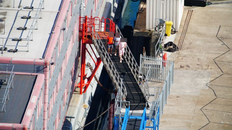 People thought to be asylum seekers arrive to board the Bibby Stockholm accommodation barge at Portland Port in Dorset, which will house up to 500 people