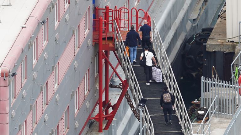 People boarding the Bibby Stockholm accommodation barge at Portland Port in Dorset. The Home Office have said around 50 asylum seekers would board the ship, with the numbers rising to its maximum capacity over the coming months, despite safety concerns raised by some of the county&#39;s Conservative MPs and locals. Picture date: Monday August 7, 2023.