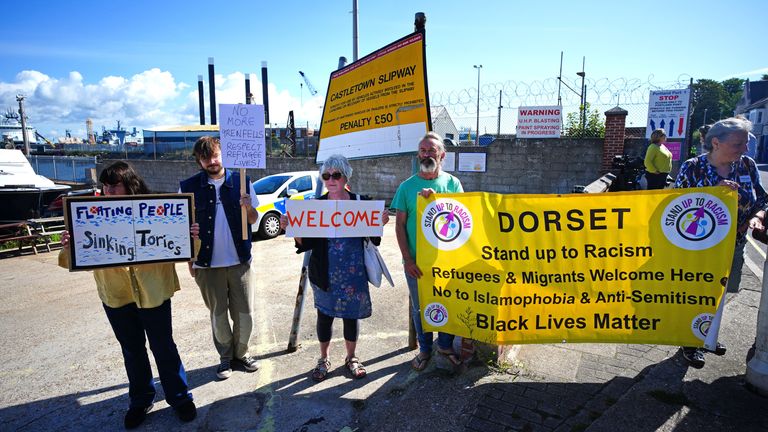 Protestor outside Portland Port in Dorset before the first asylum seekers arrive to board the Bibby Stockholm accommodation barge. The Home Office have said around 50 asylum seekers would board the Bibby Stockholm, with the numbers rising to its maximum capacity over the coming months, despite safety concerns raised by some of the county&#39;s Conservative MPs and locals. Picture date: Monday August 7, 2023. PA Photo. See PA story POLITICS Migrants. Photo credit should read: Ben Birchall/PA Wire    
