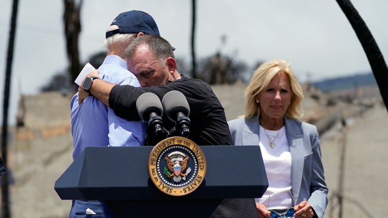 Hawaii Governor Josh Green hugs President Joe Biden before speaking after touring the areas devastated by the Maui wildfires Monday, August 21, 2023, in Lahaina, Hawaii.  (AP Photo/Evan Vucci)