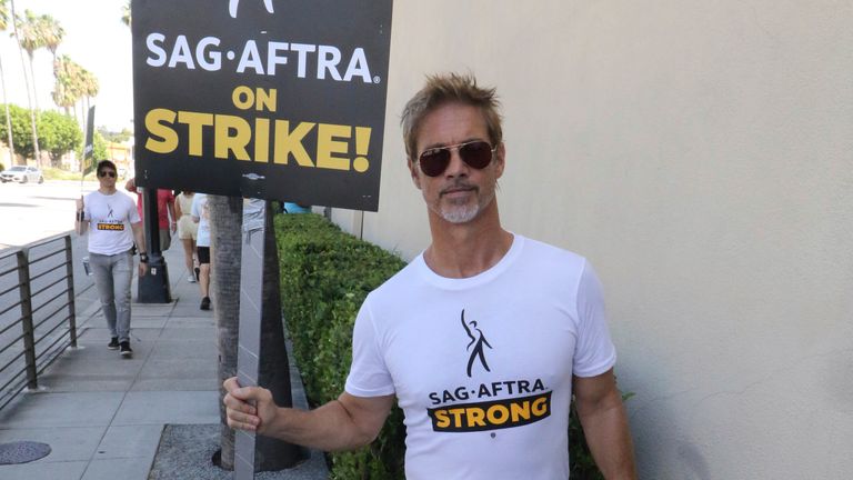Brad Pitt walks the picket line in support of the SAG-AFTRA and WGA strike on July 25, 2023 in Los Angeles, California.
