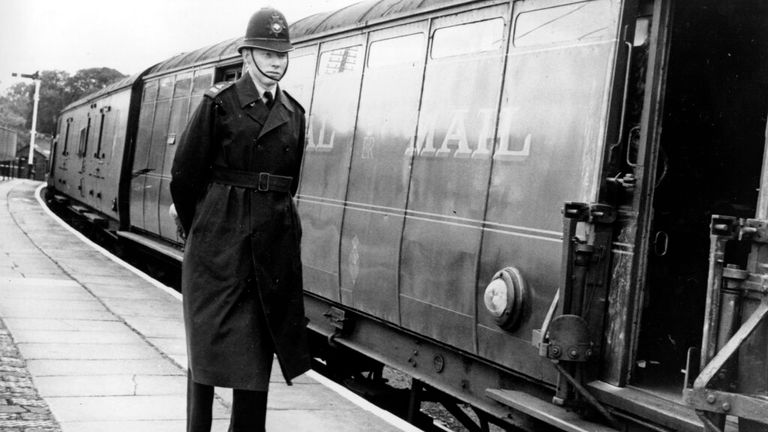 A policeman stands guard by the hi-jacked mail train in Buckinghamshire in 1963