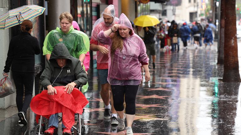 People walk along the Hollywood Walk of Fame during the tropical storm Hilary, in Los Angeles, California, U.S., August 20, 2023. REUTERS/Mario Anzuoni