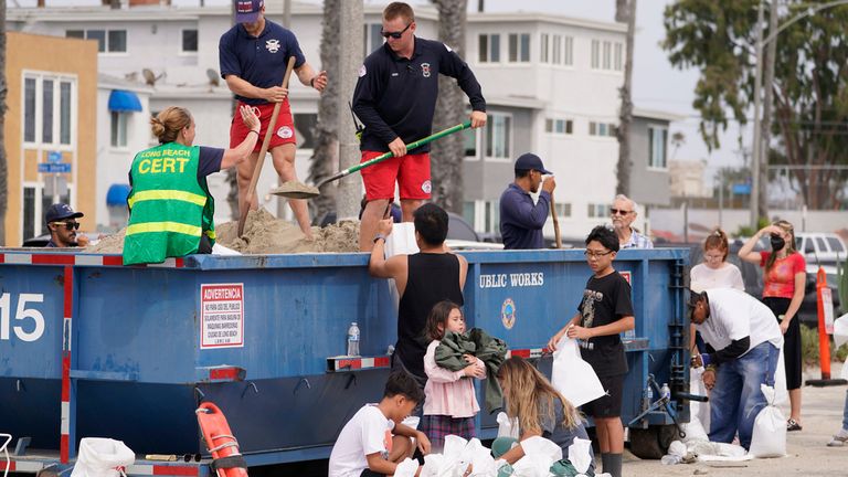 Long Beach Lifeguards fill up sandbags for residents ahead of Hurricane Hilary in Long Beach, Calif. Pic: AP