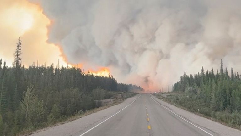 Flames and smoke rise during a wildfire in Northwest Territories, Canada, August 13, 2023, in this picture obtained from a social media video. Mary Jane Martin/via REUTERS THIS IMAGE HAS BEEN SUPPLIED BY A THIRD PARTY. NO RESALES. NO ARCHIVES.