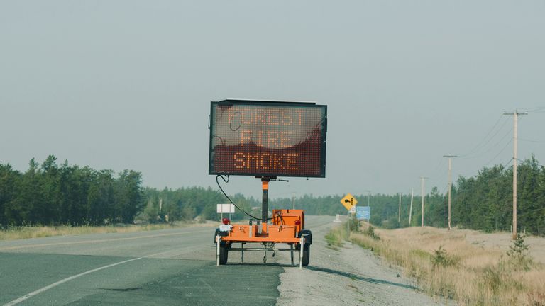 A road sign provides updates on traffic conditions on the only highway in or out of Yellowknife after a state of emergency was declared due to the proximity of a wildfire in Yellowknife, Northwest Territories, Canada August 16, 2023. REUTERS/Pat Kane