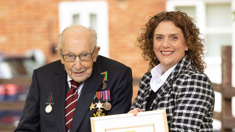 Handout photo of Second World War veteran Captain Tom Moore with his daughter Hannah, following a Battle of Britain Memorial Flight flypast of a Spitfire and a Hurricane passing over his home as he celebrates his 100th birthday.