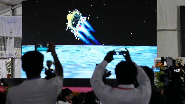 Journalists film the live telecast of spacecraft Chandrayaan-3 landing on the moon at ISRO&#39;s Telemetry, Tracking and Command Network facility in Bengaluru, India, Wednesday, Aug. 23, 2023. India was counting down to landing a spacecraft near the moon&#39;s south pole Wednesday, an unchartered territory that scientists believe could hold important reserves of frozen water and precious elements. (AP Photo/Aijaz Rahi)