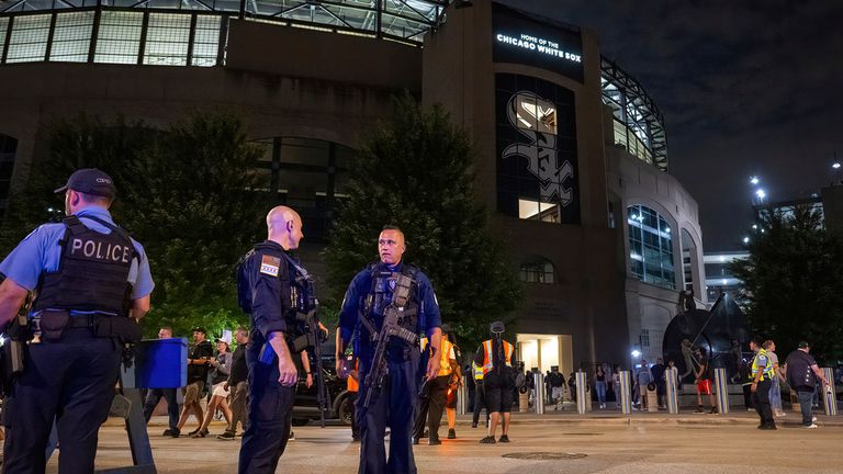 Chicago police officers stand outside Guaranteed Rate Field on Friday night, Aug. 25, 2023, in Chicago. Police are investigating a shooting at a White Sox baseball game a the stadium Friday night. Police said the investigation is ongoing. (Tyler Pasciak LaRiviere/Chicago Sun-Times via AP)
