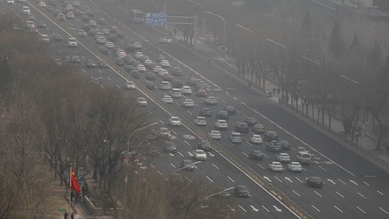 Cars move on a street on a polluted day in Beijing, China March 7, 2023. REUTERS/Tingshu Wang