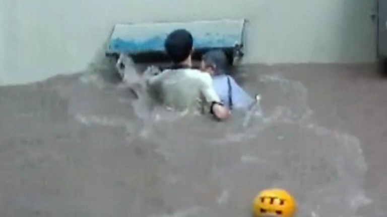 Man who cannot swim braves deluge to rescue woman in flood water