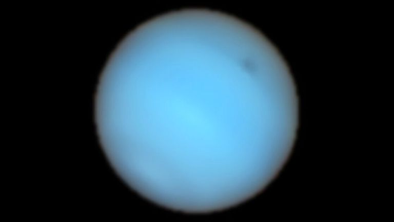 A mysterious dark spot on Neptune has been detected from Earth for the first time 
Pic:ESO/P. Irwin et al/PA