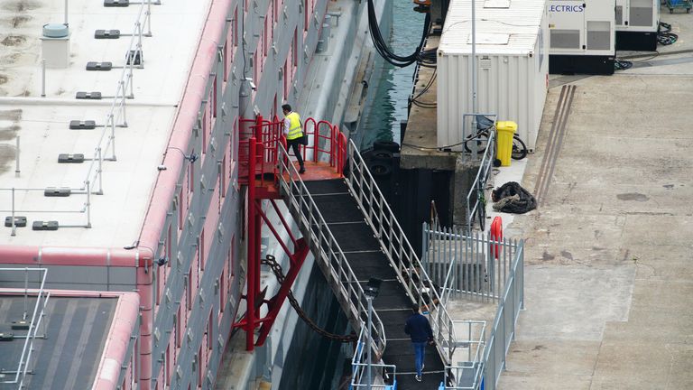 People boarding the Bibby Stockholm accommodation barge at Portland Port in Dorset, which will house up to 500 Asylum seekers. Picture date: Tuesday August 8, 2023.