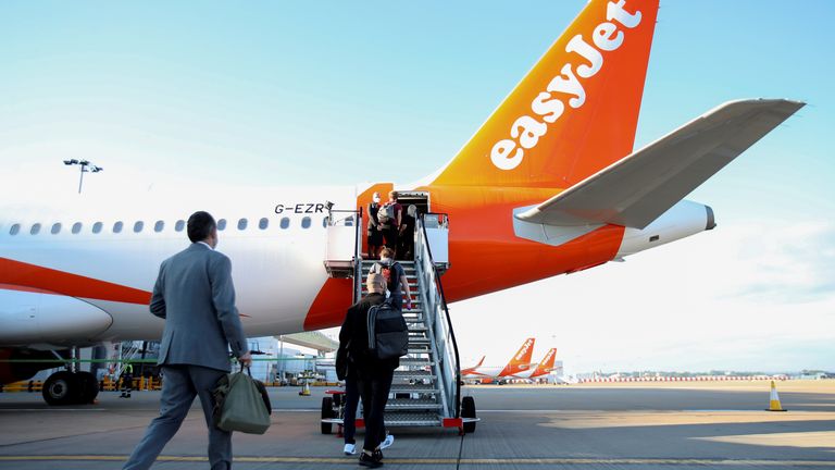 Passengers board a plane as EasyJet restarts its operations amid the coronavirus disease (COVID-19) outbreak at Gatwick Airport, in Gatwick, Britain June 15, 2020. REUTERS/Peter Cziborra
