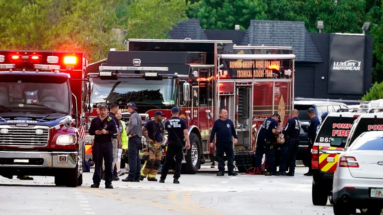 Fire and rescue personnel work in the area where a medical rescue helicopter crashed, Monday, Aug. 28, 2023, in Pompano Beach, Fla. (AP Photo/Marta Lavandier)