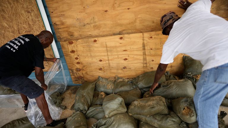 Men work to reinforce a law firm&#39;s office on 2nd Street. Pic: AP