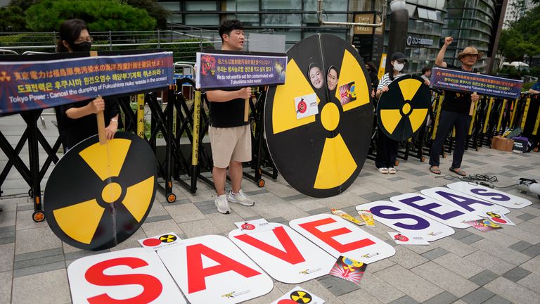 Members of environmental civic groups shout slogans during a rally to denounce the Japanese government&#39;s decision to release treated radioactive water into the sea from the damaged Fukushima nuclear power plant, outside of a building which houses Japanese Embassy, in Seoul, South Korea, Tuesday, Aug. 22, 2023. Japan will start releasing treated and diluted radioactive wastewater from the Fukushima Daiichi nuclear plant into the Pacific Ocean as early as Thursday, a controversial but essential early step in the decades of work to shut down the facility 12 years after its meltdown disaster. (AP Photo/Lee Jin-man)