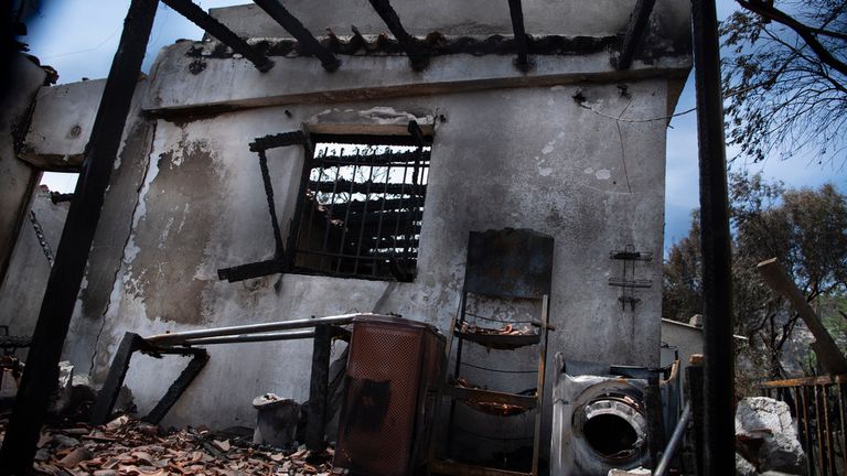 A burned house stands in Acharnes suburb. Pic: AP