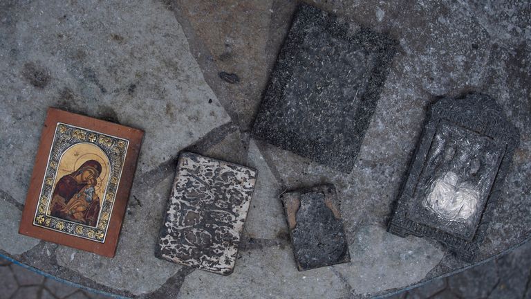 Burned holy icons are seen in Acharnes suburb, on Mount Parnitha. Pic: AP