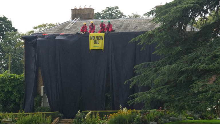 Greenpeace activists on the roof of Prime Minister Rishi Sunak&#39;s house in Richmond, North Yorkshire after covering it in black fabric in protest at his backing for expansion of North Sea oil and gas drilling. Picture date: Thursday August 3, 2023.