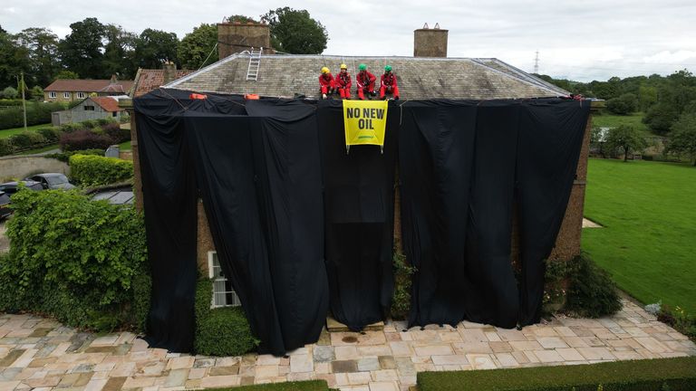 PABest Greenpeace activists on the roof of Prime Minister Rishi Sunak&#39;s house in Richmond, North Yorkshire, after covering it in black fabric in protest at his backing for expansion of North Sea oil and gas drilling. Picture date: Thursday August 3, 2023.