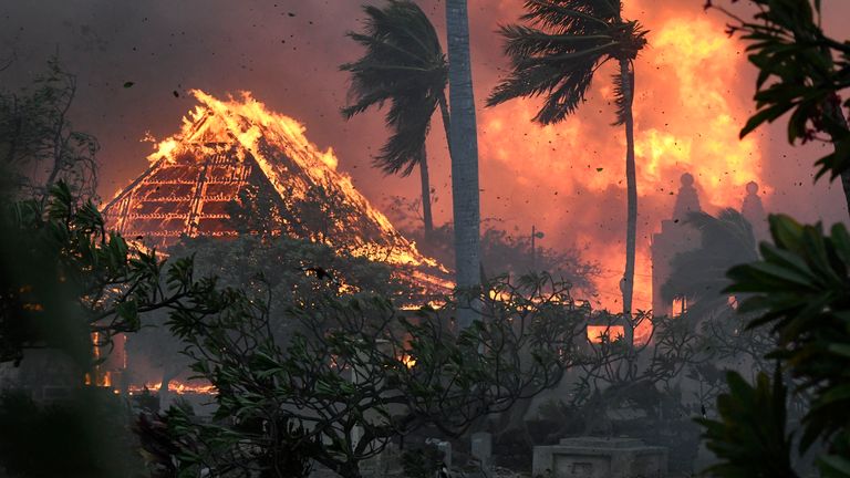 The hall of historic Waiola Church in Lahaina and nearby Lahaina Hongwanji Mission are engulfed in flames along Wainee Street on Tuesday, Aug. 8, 2023, in Lahaina, Hawaii. (Matthew Thayer/The Maui News via AP)