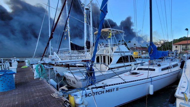Smoke billows near boats docked at Lahaina as wildfires driven by high winds destroy a large part of the historic town of Lahaina, Hawaii, U.S. August 9, 2023. Dustin Johnson/Handout via REUTERS THIS IMAGE HAS BEEN SUPPLIED BY A THIRD PARTY. REFILE - REMOVING KAHULUI
