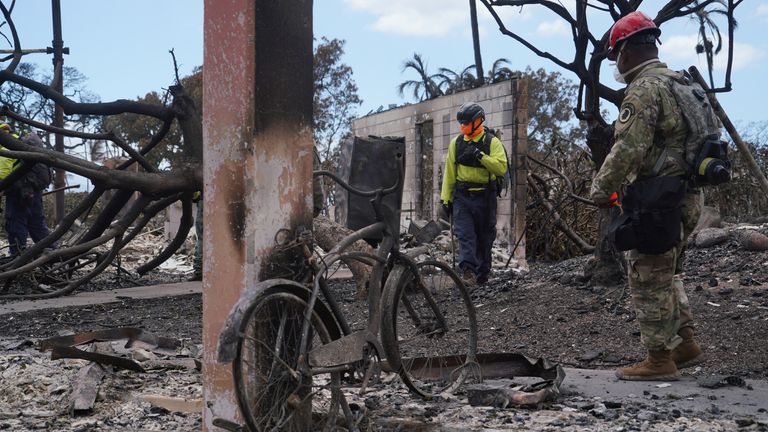 Emergency workers are searching through the ruins of Lahaina on the island of Maui