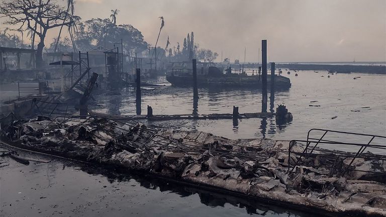 A charred boat lies in the scorched waterfront. Pic: Mason Jarvi