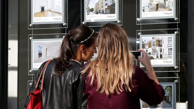 File photo dated 08/06/2016 of a couple of women studying the house price signs in an estate agents window, in Kentish Town, London. 