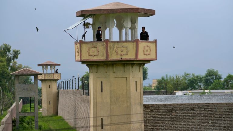 Police officers stand guard on the watch towers of district prison Attock