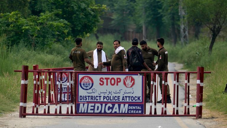 Police officers barricade a road leading to district prison Attock, 